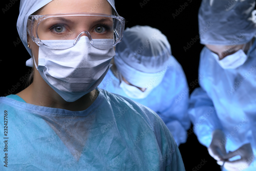 Medical team performing operation. Focus at female doctor 