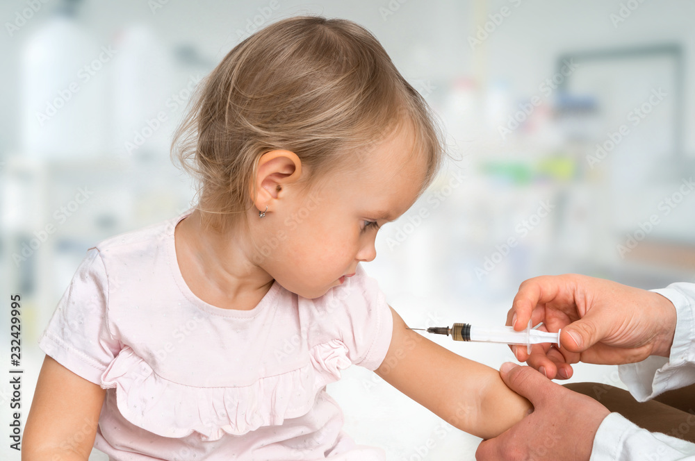 Pediatrician doctor is injecting vaccine to shoulder of baby Pediatrician doctor is injecting vaccine to shoulder of baby