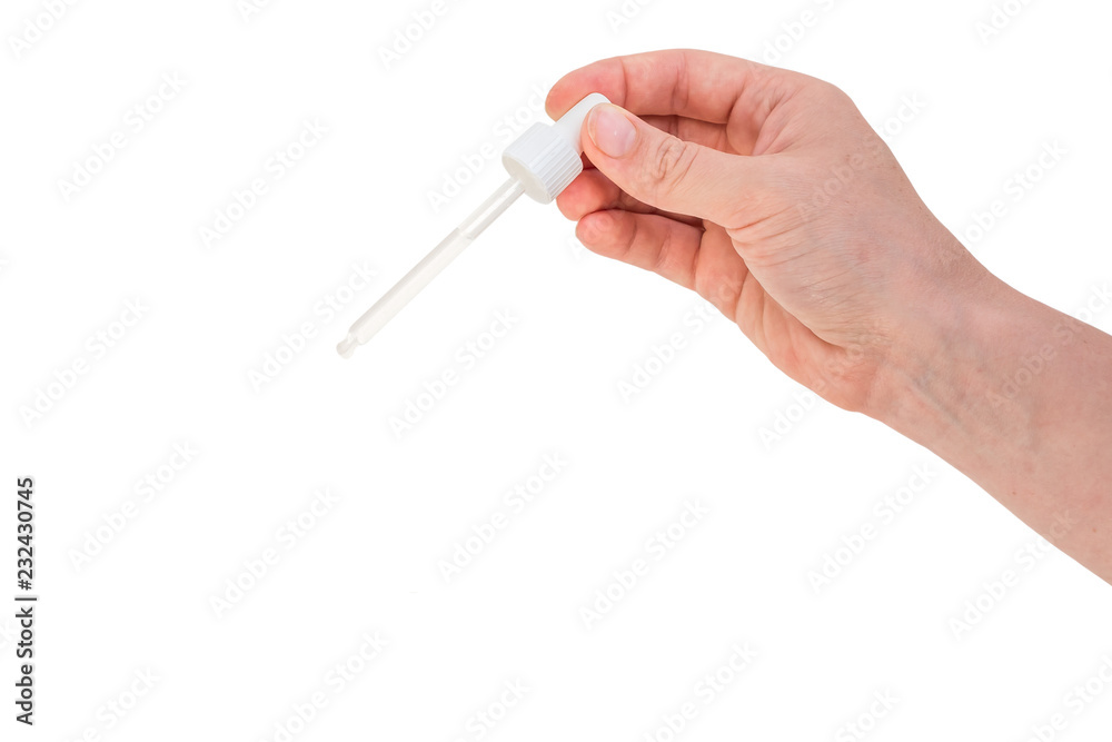Hand of woman is holding pipette with liquid Hand of woman is holding pipette with liquid