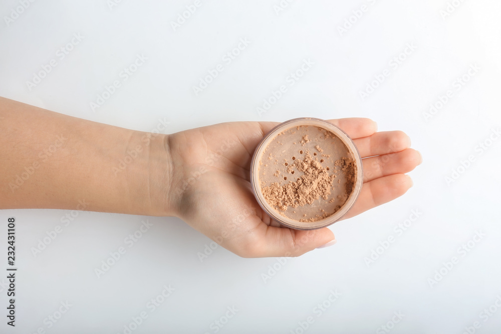 Fototapeta premium Woman holding powder on white background