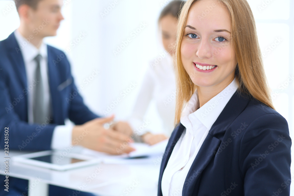 Group of business people or lawyers discussing terms of transaction in office. Focus at young business woman. Meeting and teamwork concept Group of business people or lawyers discussing terms of transaction in office. Focus at young business woman. Meeting and teamwork concept