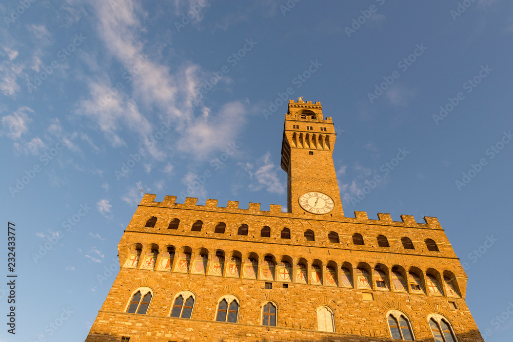 FLORENCE, ITALY - OCTOBER 28, 2018: The Palazzo Vecchio is the town hall of Florence, Italy.  David statue as well as the gallery of statues in the adjacent Loggia dei Lanzi.