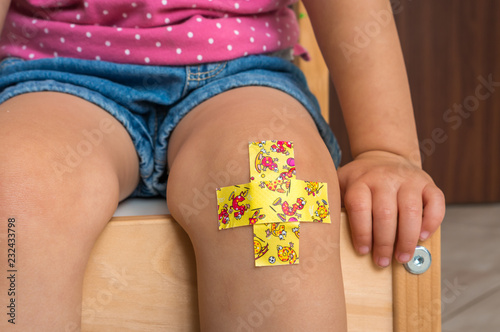 Fotobehang Child with adhesive bandage on knee