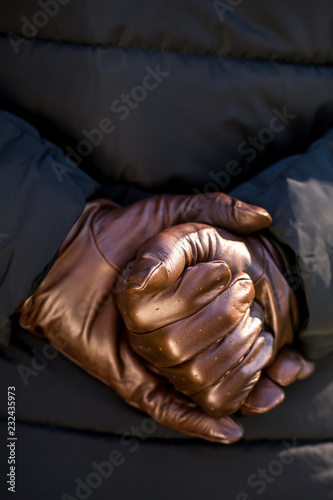 hands in brown leather gloves