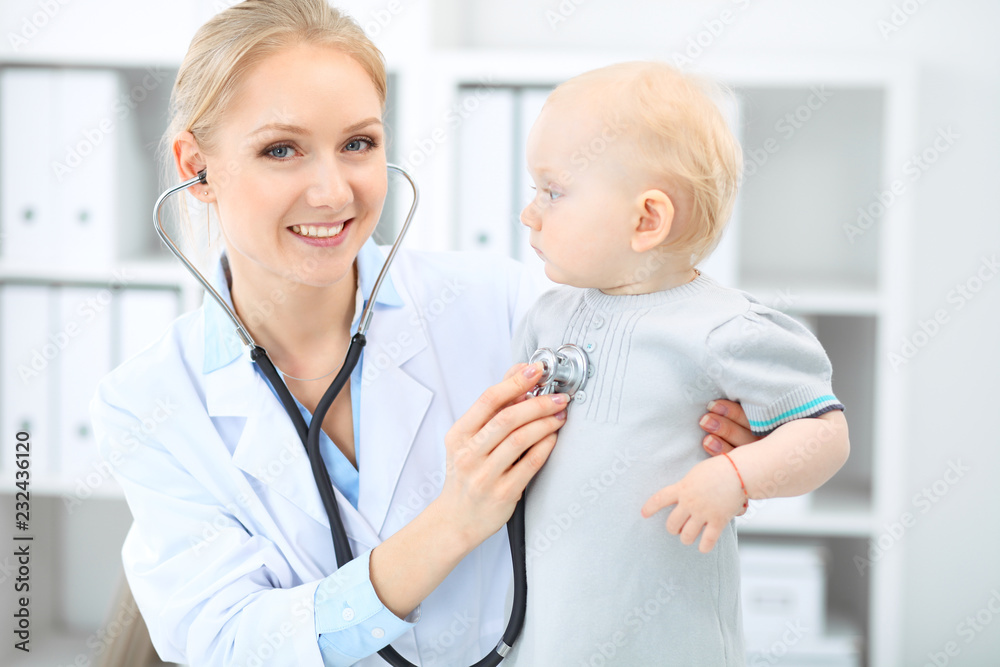 Doctor and patient in hospital. Little girl is being examined by pediatrician with stethoscope. Medicine and health care Doctor and patient in hospital. Little girl is being examined by pediatrician with stethoscope. Medicine and health care