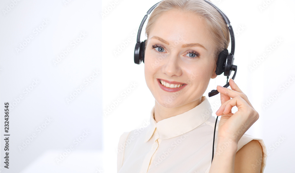 Bright call center office. Two blonde women in a headset Bright call center office. Two blonde women in a headset
