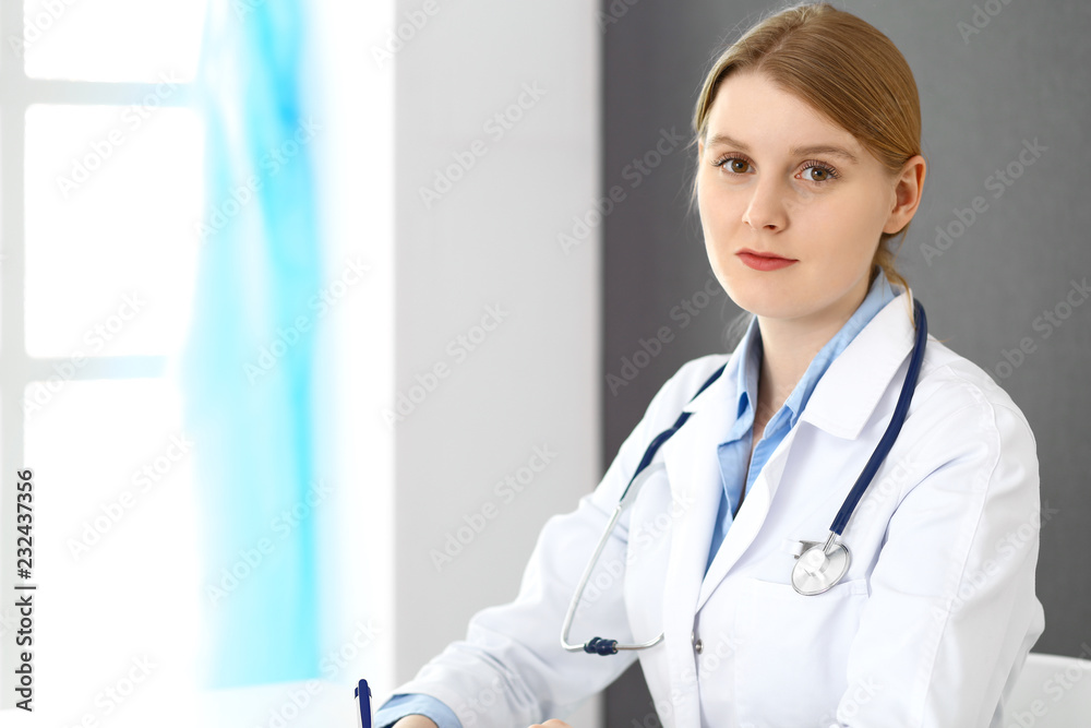 Doctor woman filling up prescription or medical record form while sitting near window in clinic or hospital. Medicine and healthcare concept. Physician at work Doctor woman filling up prescription or medical record form while sitting near window in clinic or hospital. Medicine and healthcare concept. Physician at work