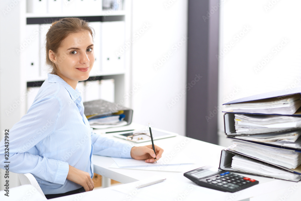 Woman bookkeeper or financial inspector calculating or checking balance, making report. Internal Revenue Service at work with financial document. Tax and audit concept
