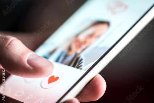 Dating app or site in mobile phone screen. Man swiping and liking profiles on relationship site or application. Single guy using smartphone to find love, partner and girlfriend. Mockup website.