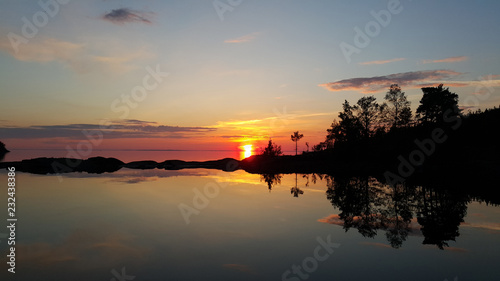 Fototapeta Naklejka Na Ścianę i Meble -  Sunset above the silent water.