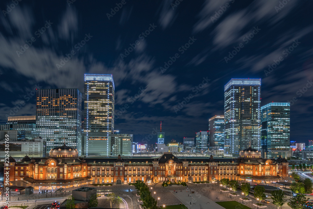Night panoramic view of Marunouchi side of Tokyo railway station in the Chiyoda City, Tokyo, Japan. The station is divided into Marunouchi and Yaesu sides in its directional signage. Night panoramic view of Marunouchi side of Tokyo railway station in the Chiyoda City, Tokyo, Japan. The station is divided into Marunouchi and Yaesu sides in its directional signage.
