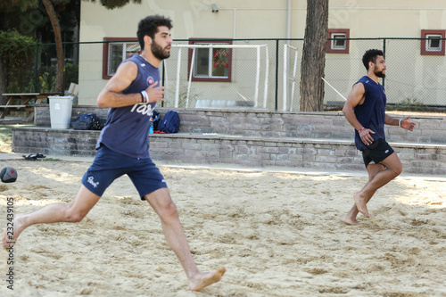 men training in the sand