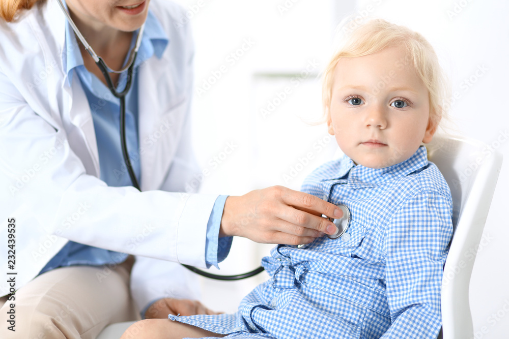 Doctor examining a little blonde girl with stethoscope.Medicine and healthcare concept Doctor examining a little blonde girl with stethoscope.Medicine and healthcare concept