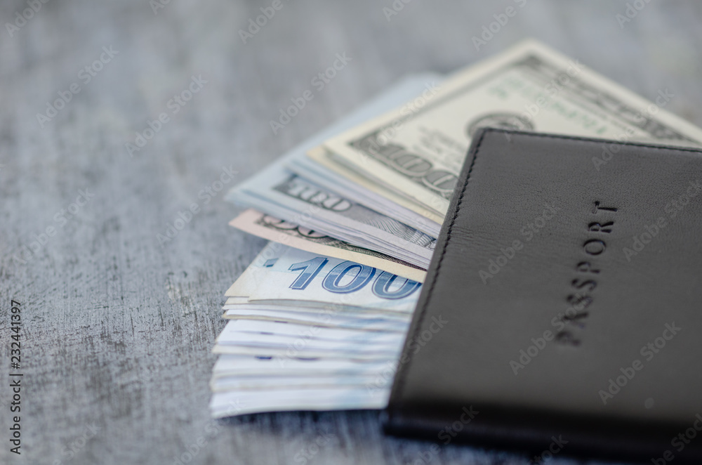 Leather-sheathed passport and cash lira and dollars banknotes on the table. Leather-sheathed passport and cash lira and dollars banknotes on the table.