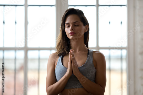 Portrait of young attractive woman, meditating with namaste gesture, doing restorative yoga exercise, beautiful lady in relaxation pose, stress relief breathing technique. Well-being concept Free Download Portrait of young attractive woman, meditating with namaste gesture, doing restorative yoga exercise, beautiful lady in relaxation pose, stress relief breathing technique. Well-being concept - GFXLoad