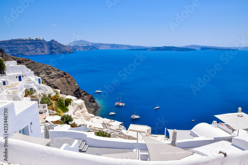 Panoramic aerial view of traditional white buildings and volcanic caldera at Oia  Santorini Island  Greece