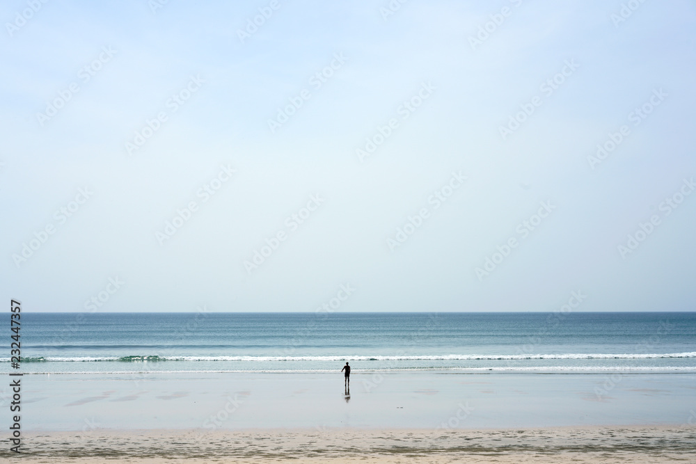 man walking on the beach