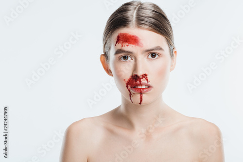 Obraz na płótnie female victim of domestic violence with blood on face isolated on white