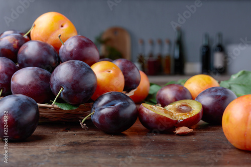 Ripe juicy plums on a kitchen table.