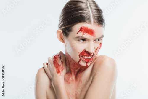 aggressive adult naked woman with blood on skin isolated on white, domestic violence concept