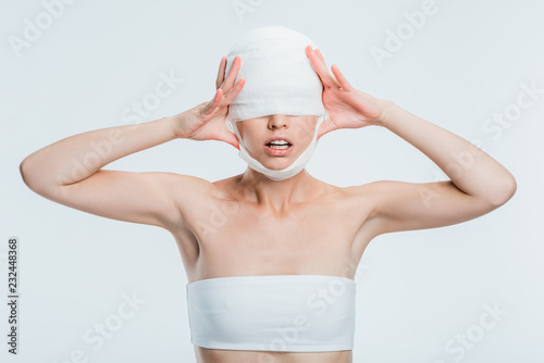 Wallpaper Mural woman with bandages touching head isolated on white Torontodigital.ca