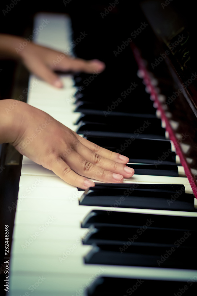 Obraz premium Hands Playing on Piano Keys