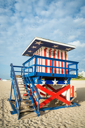 Classic red, white, and blue American theme stars and stripes lifeguard tower in traditional wood on South Beach in Miami, Florida, USA © lazyllama