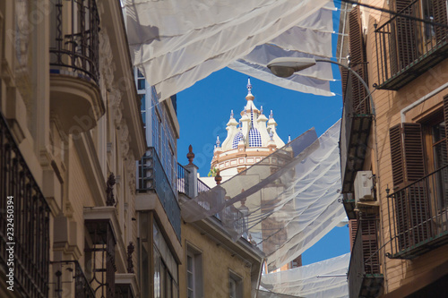 Fototapeta Naklejka Na Ścianę i Meble -  Shadow curtains on the street in Seville, Spain protecting tourists from sun and heat.