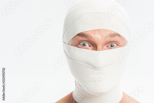 Canvas Print close up of man face covered with white bandages after plastic surgery isolated