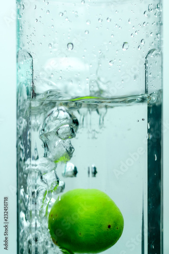 A Green Lime Splashes into a Jar of Water