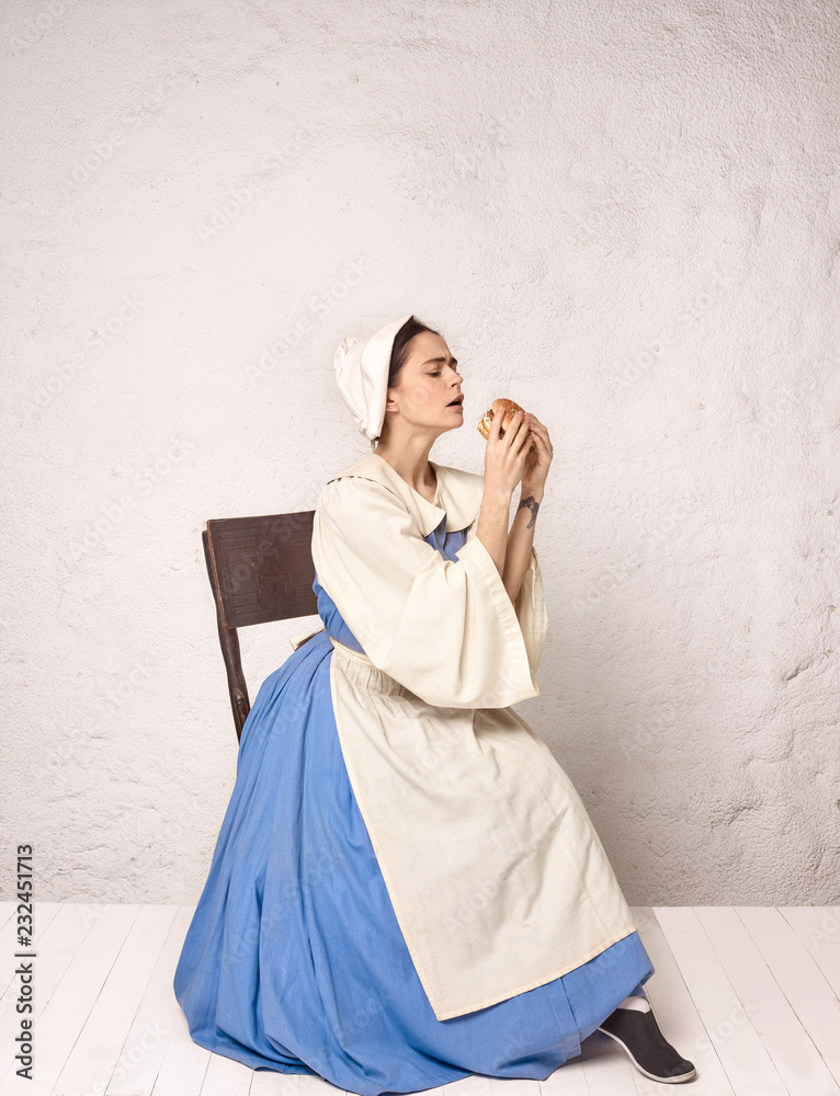 Medieval Woman in Historical Costume Wearing Corset Dress and Bonnet. Medieval Woman in Historical Costume Wearing Corset Dress and Bonnet.