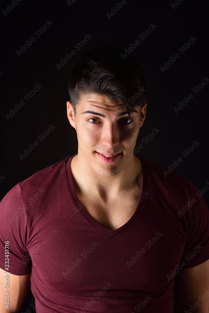 portrait of a young man on black background