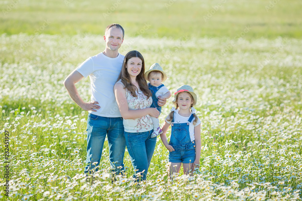 Young family in a field of flowers daises chamomile anjoy spa life happy together with cute faces in a village rustic motion Young family in a field of flowers daises chamomile anjoy spa life happy together with cute faces in a village rustic motion