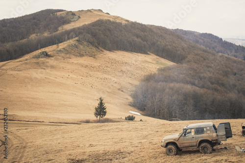 Travel by car in the mountains. Offroad. The view from the window on the mountains and forests of the Ukrainian Carpathians. Dirty jeeps.