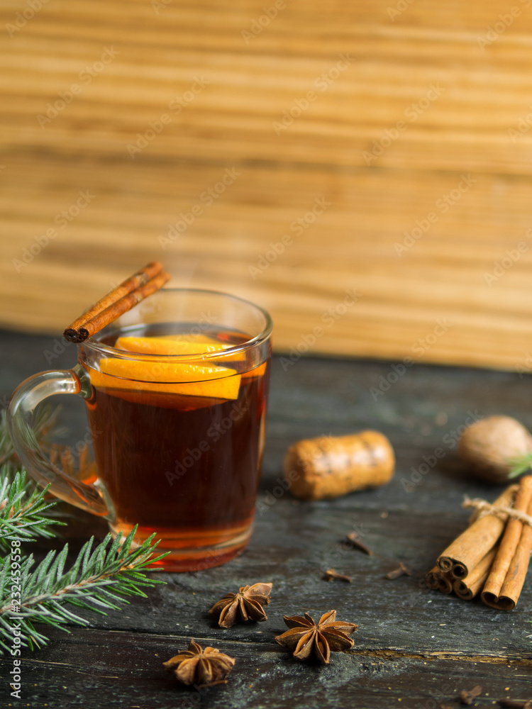 Hot winter drink mulled wine on dark wooden table Hot winter drink mulled wine on dark wooden table
