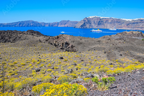 Spectacular landscape on Nea Kameni volcano with Imerovigli village in the background, Santorini Island, Greece