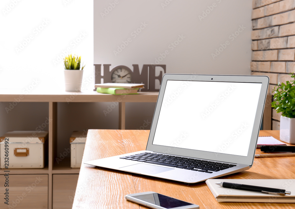 Home workplace with laptop on table Home workplace with laptop on table