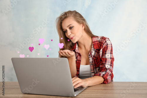 Young woman using laptop fo...