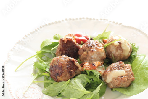 homemade meat ball served with baby leaves and ketchup
