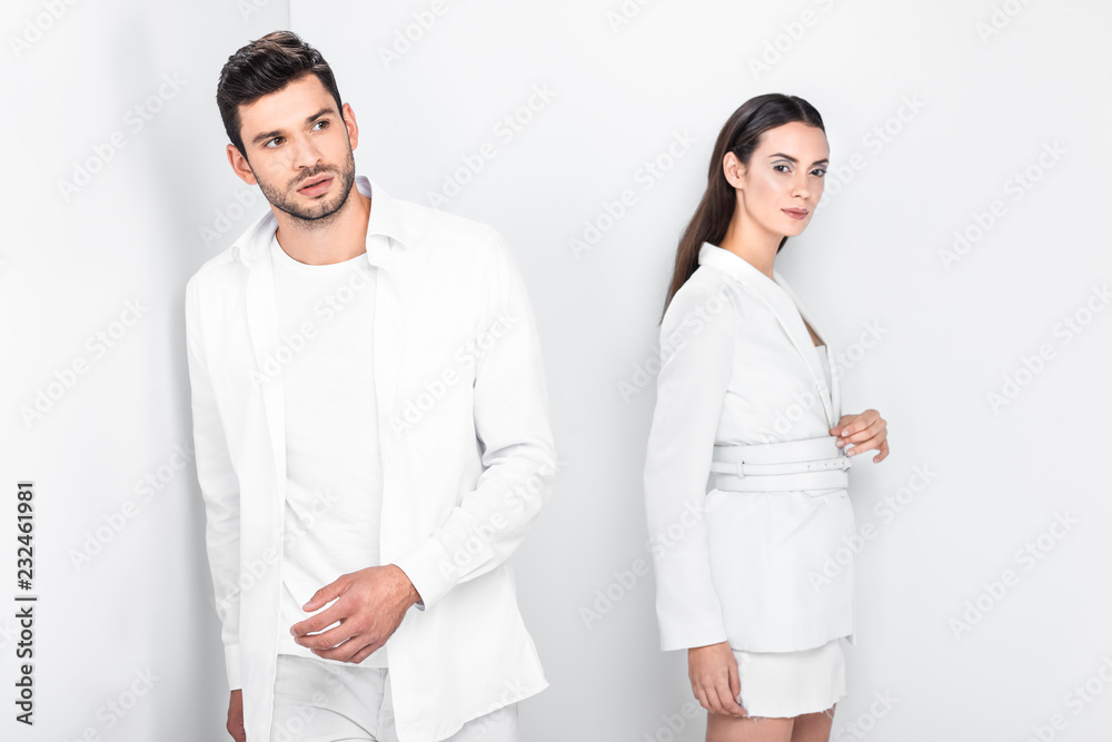 adult fashionable couple in total white posing together adult fashionable couple in total white posing together
