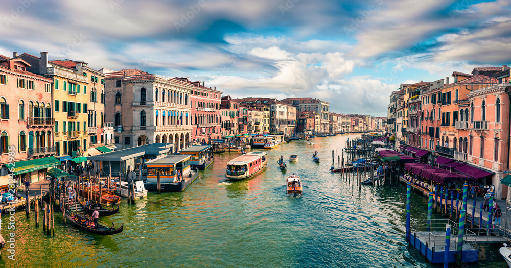 Great scene of famous Canal Grande. Colorful spring view from Rialto Bridge of Venice, Italy, Europe. Picturesque morning seascape of Adriatic Sea. Traveling concept background.