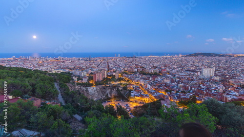 View of Barcelona day to night timelapse, the Mediterranean sea, The tower Agbar and The twin towers from Bunkers Carmel. Catalonia, Spain.