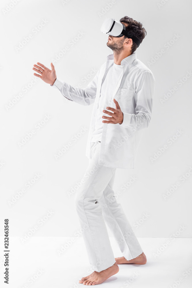 adult man in total white wearing virtual reality headset