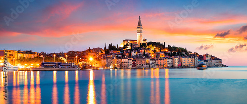 Fantastic spring sunset of Rovinj town, Croatian fishing port on the west coast of the Istrian peninsula. Colorful evening seascape of Adriatic Sea. Traveling concept background.