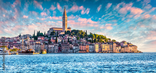 Great spring sunset of Rovinj town, Croatian fishing port on the west coast of the Istrian peninsula. Colorful evening seascape of Adriatic Sea. Traveling concept background.