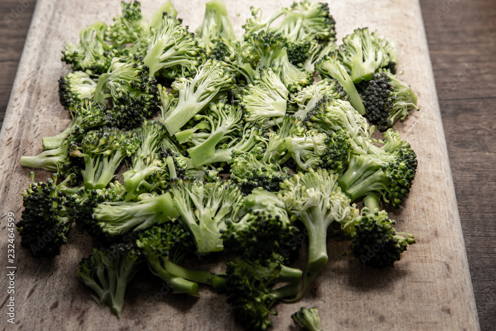 Cutted fresh green broccoli over wooden background Cutted fresh green broccoli over wooden background