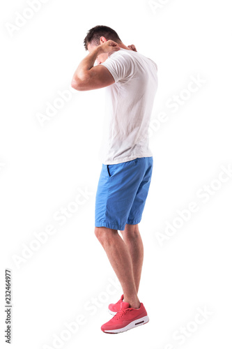 Side view of young adult in summer clothes adjusting t-shirt and walking. Full body isolated on white background. 