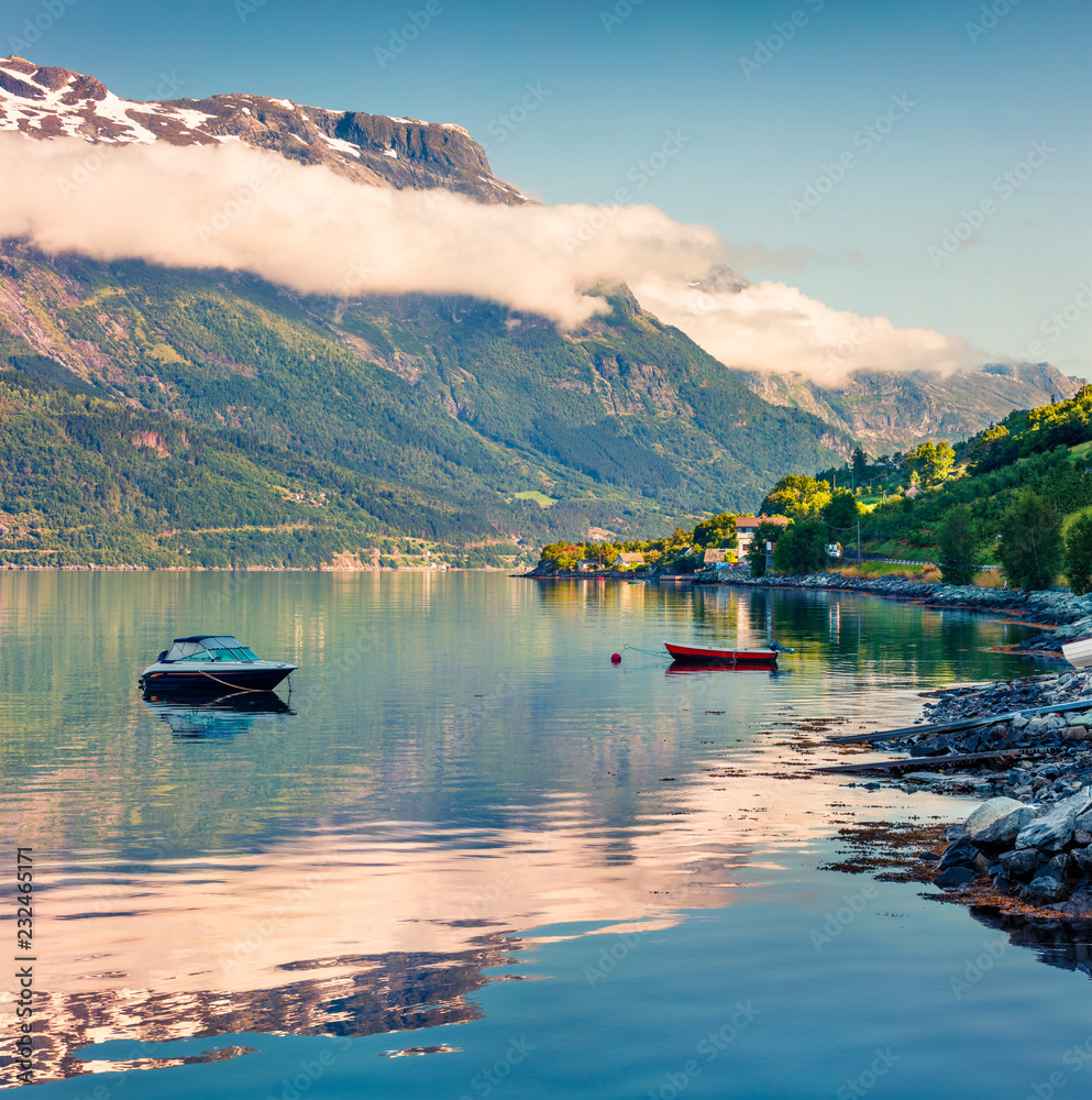 Calm summer morning in Lofthus village in Ullensvang municipality which is located in the Hardanger region of Hordaland county, Norway. Beauty of countryside concept background.