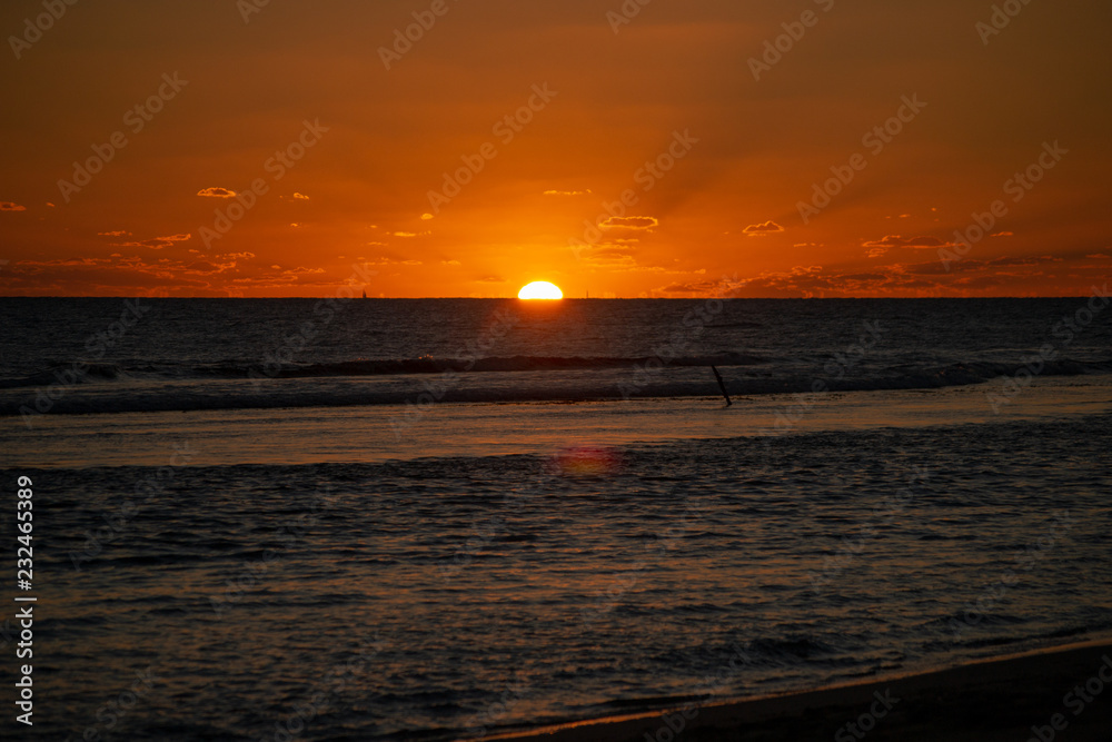Sunset at the beach with orange colors