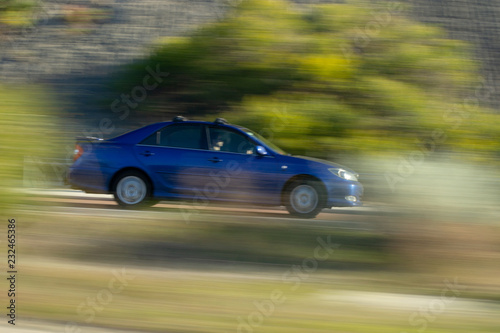 Motion blur of a blue car over the road © Maria